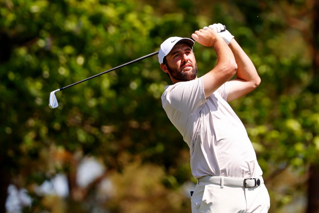 Scottie Scheffler plays his shot from the fourth tee during the final round of the Masters Tournament at Augusta National Golf Club.
