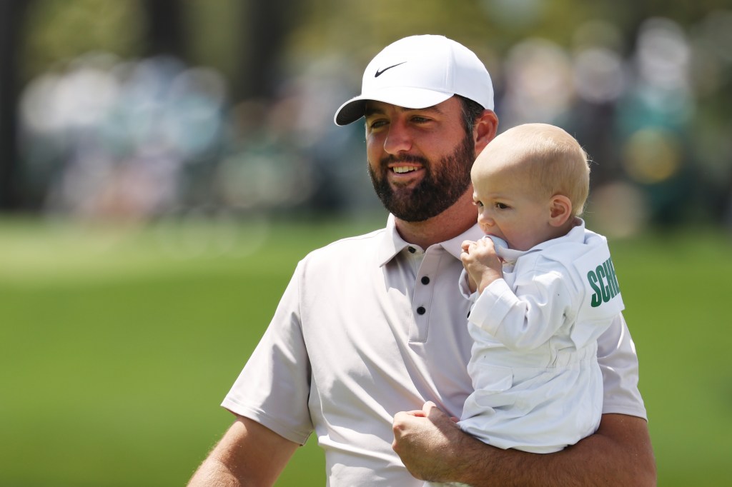 The two-time Masters champion held his son while walking through Augusta National.