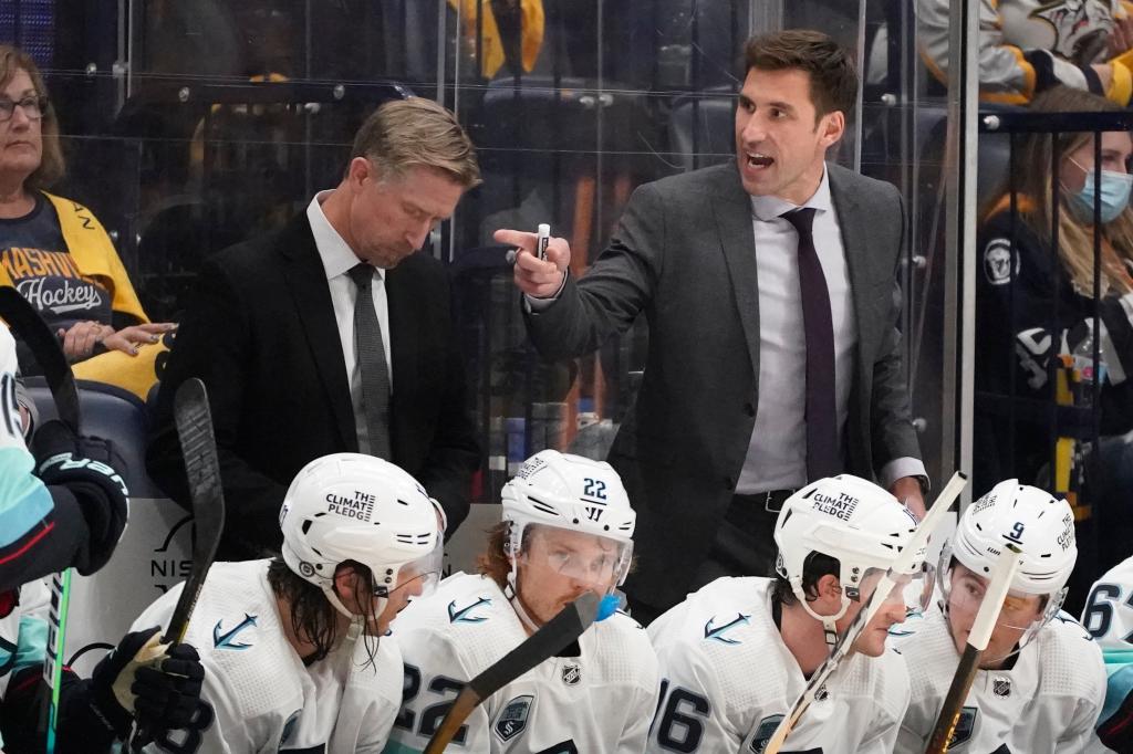 Seattle Kraken assistant coach Jay Leach, right, yells to players in the second period of an NHL hockey game against the Nashville Predators Thursday, Oct. 14, 2021