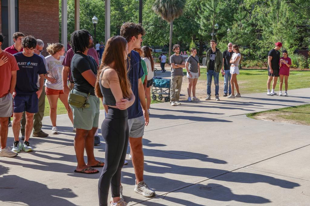 Students wait to retrieve their personal items from the Florida State Student Union building on April 18.
