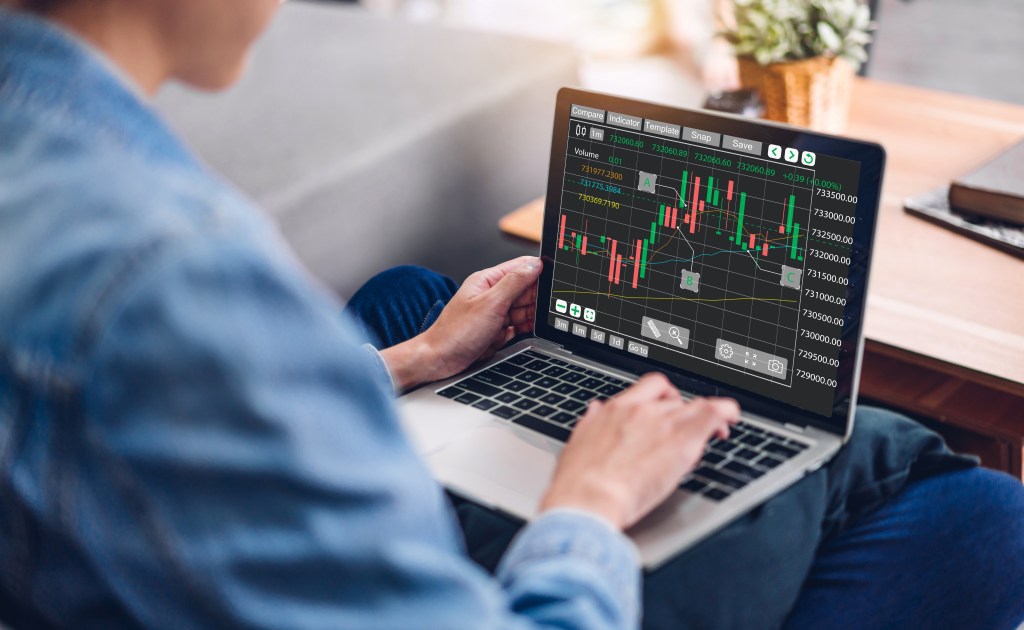 Successful of business trader investor woman use technology laptop trading graph of block chain stock market cryptocurrency investment selling and buy with price chart data graph.