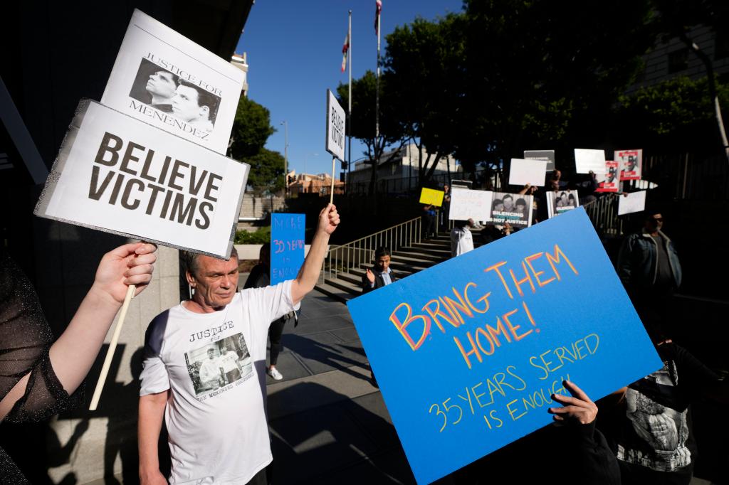 Supporters hold signs during a press conference regarding developments in the Menendez brothers case Thursday, March 20, 2025, in Los Angeles.