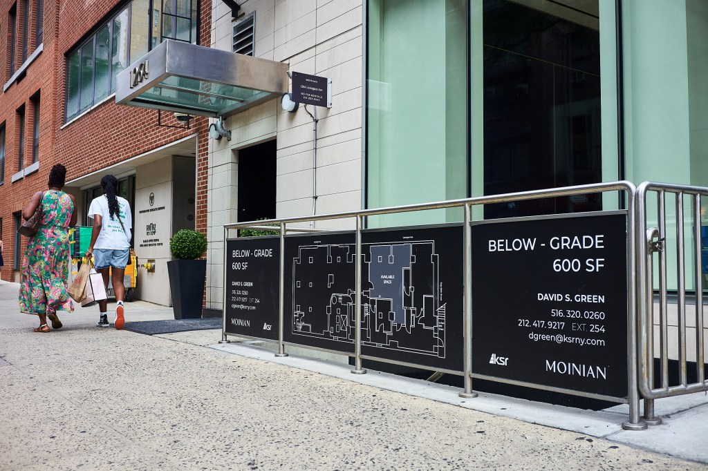 A manhattan sidewalk outside of a building