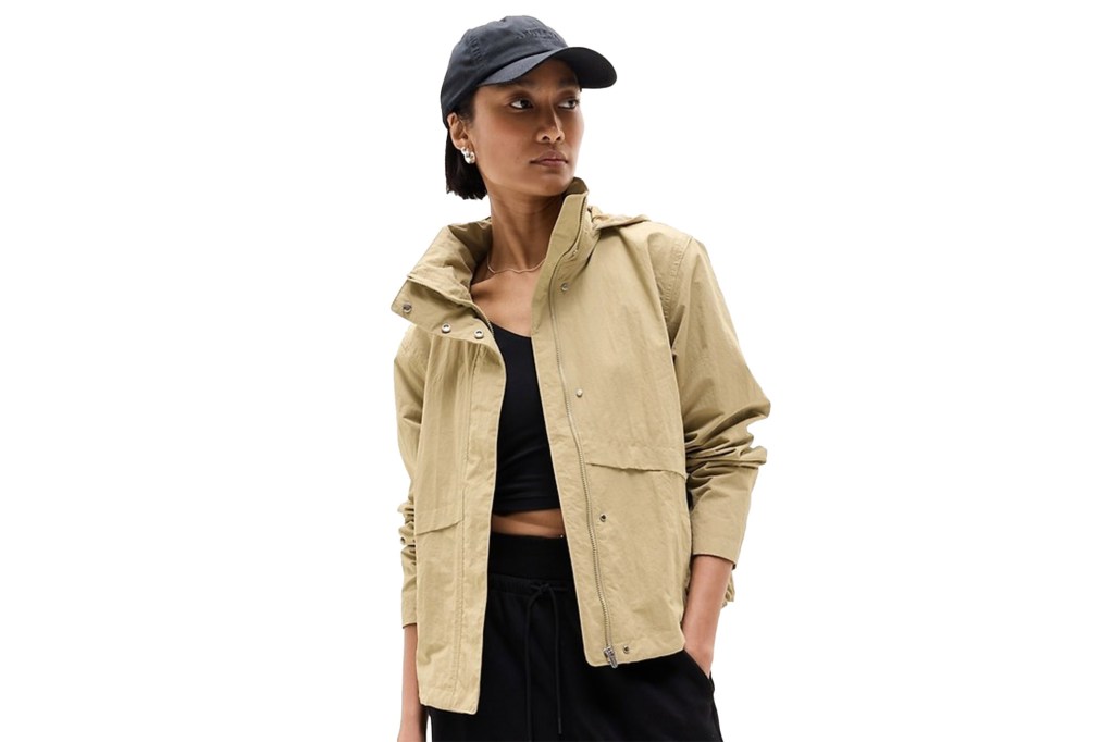 Woman in a cropped trench coat. 