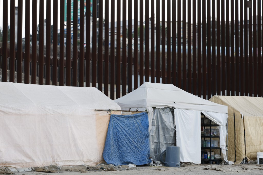 Tens line up at the US-Mexico border wall on Jan. 22, 2025.