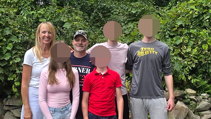 Sanger poses for a photo with her family including her four children.