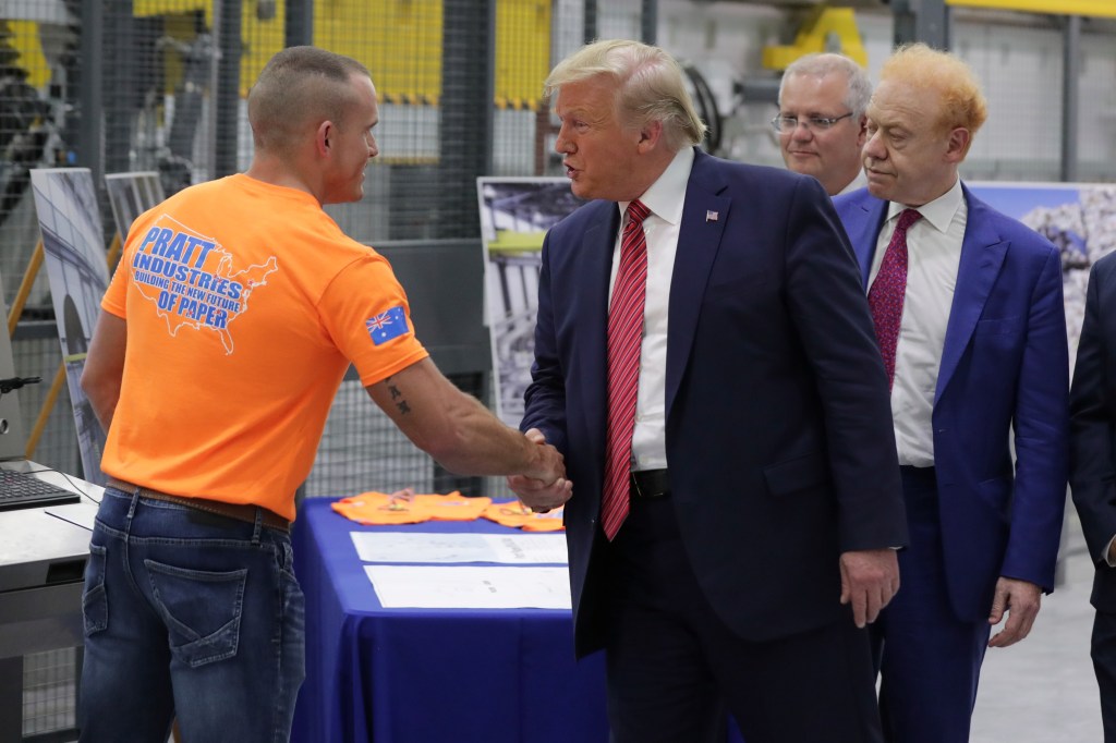 US President Donald Trump, Australian businessman Anthony Pratt and Australian Prime Minister Scott Morrison speak to a worker at Pratt Industries Wapakoneta, a recycling and paper plant owned by Anthony Pratt in Wapakoneta, Ohio, September 22, 2019.