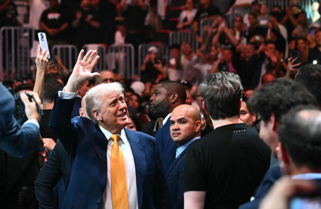 President Donald Trump reacts to the crowd as he enters the Kaseya Center for UFC 314.