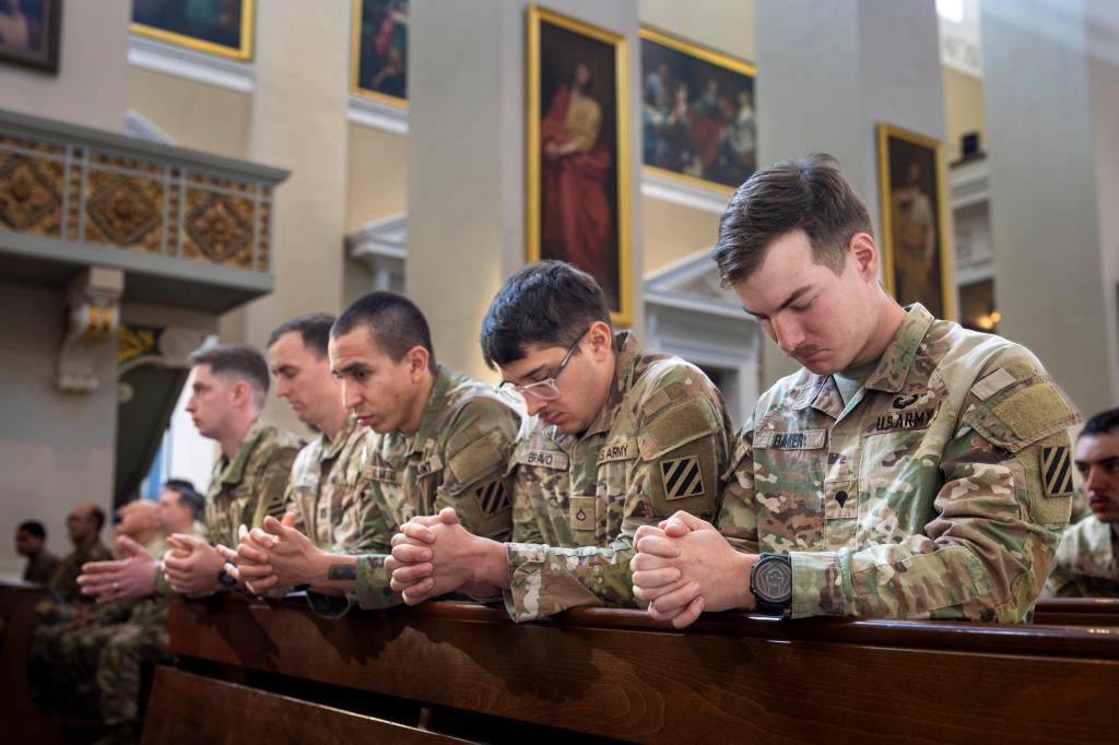 US soldiers attending a Holy Mass in Cathedral Basilica, Vilnius, Lithuania, praying for their missing colleagues from Pabrade training ground exercises