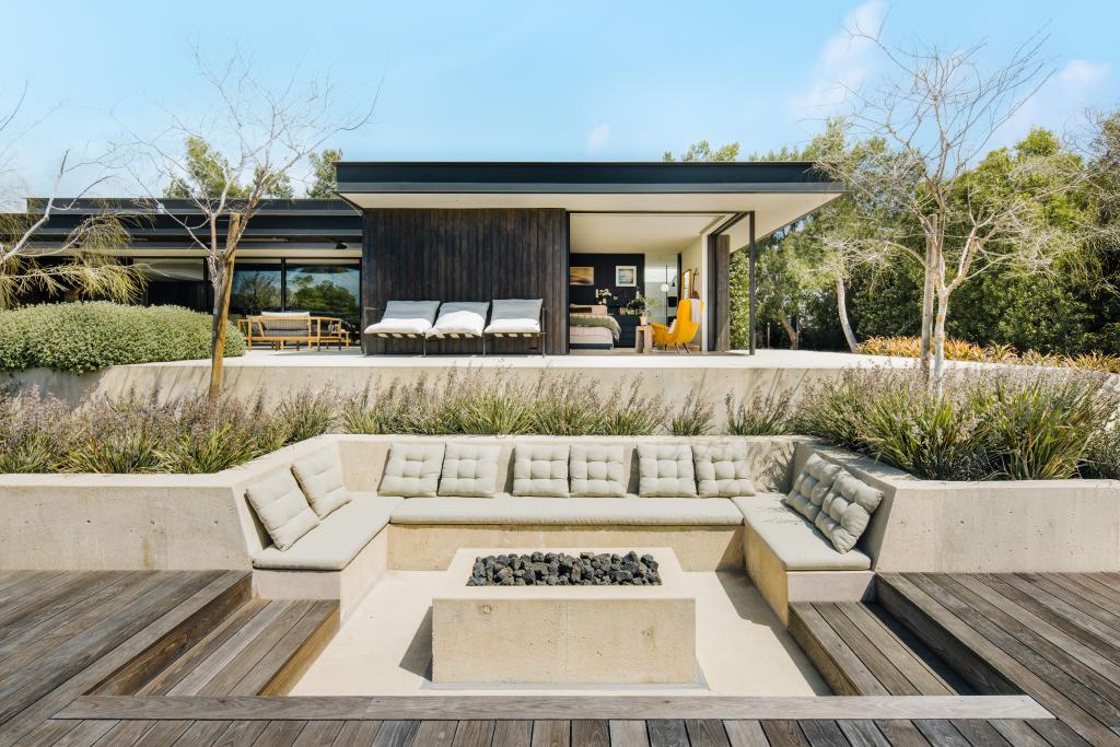 A sunken firepit built into the wooden deck.