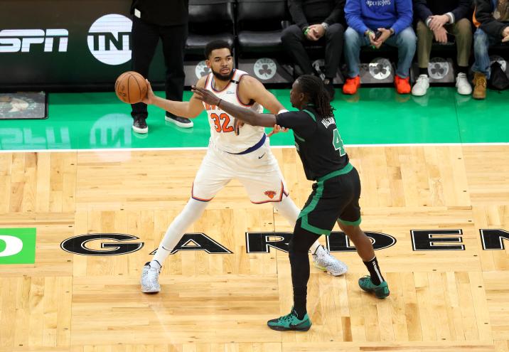 Karl-Anthony Towns #32 of the New York Knicks looks for an opening as Jrue Holiday #4 of the Boston Celtics defends during the first quarter.