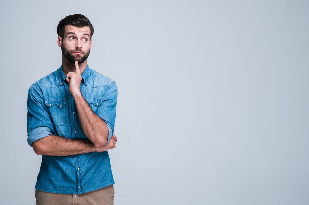 Humming is a harmless activity that may or may not stimulate your vagus nerve. Here, a man hums and points to his chin.