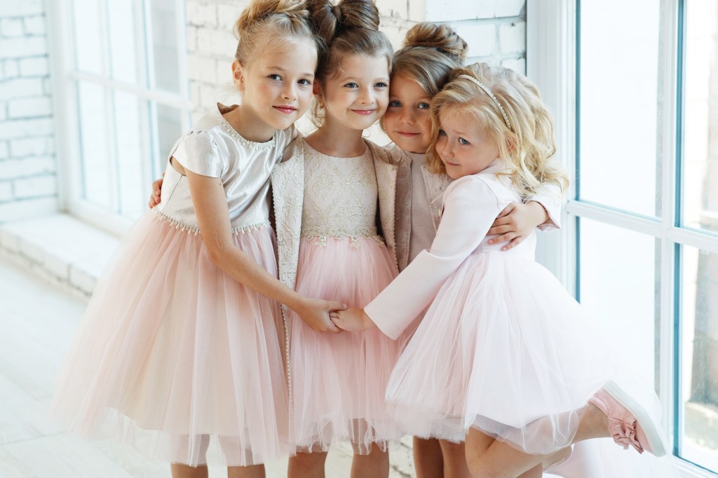 Claudia Schmidt posing with little girls in beautiful dresses