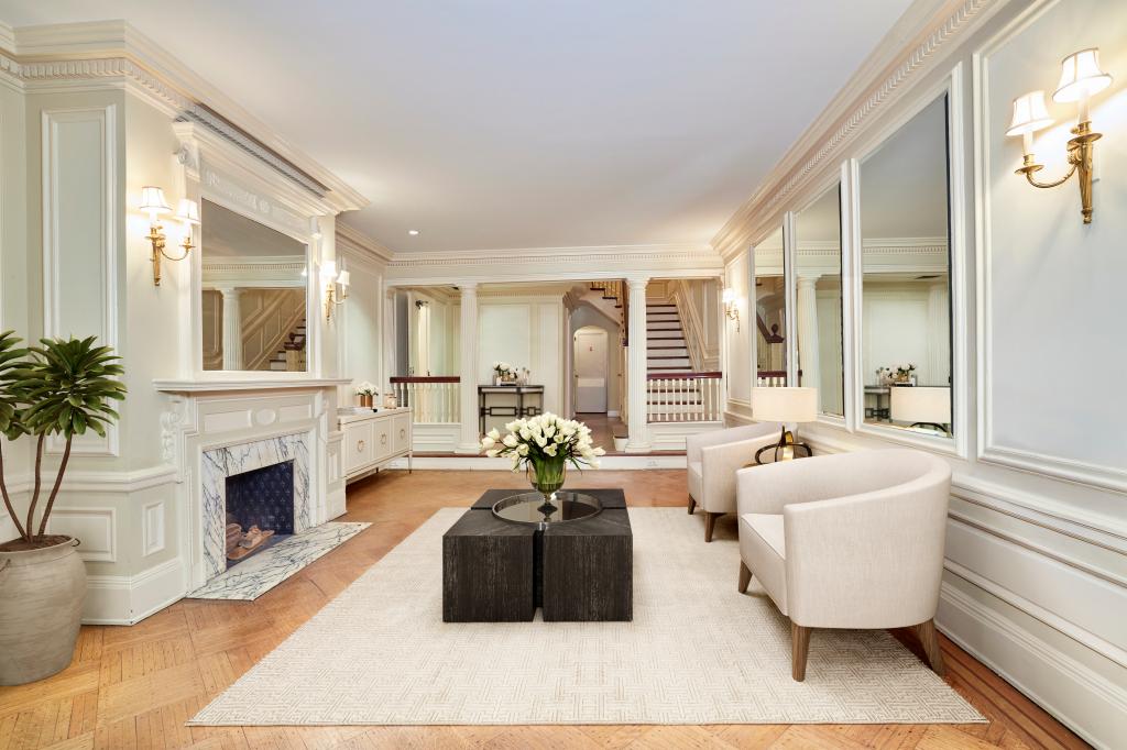 A spacious sitting area with picture frame molding.