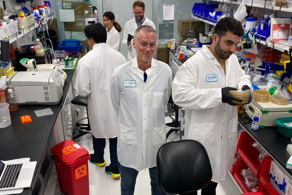 Friede seen standing in the middle of Centivax labs.