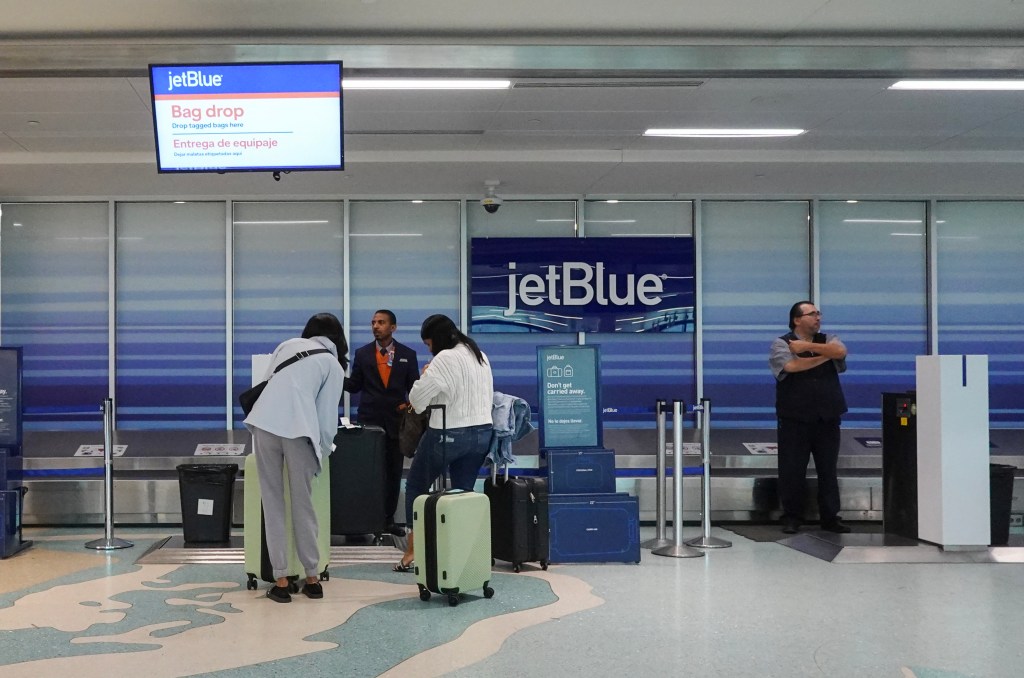 People checking in their bags at the JetBlue Airways counter at the Fort Lauderdale-Hollywood International Airport, Fort Lauderdale, Florida on January 31, 2024.