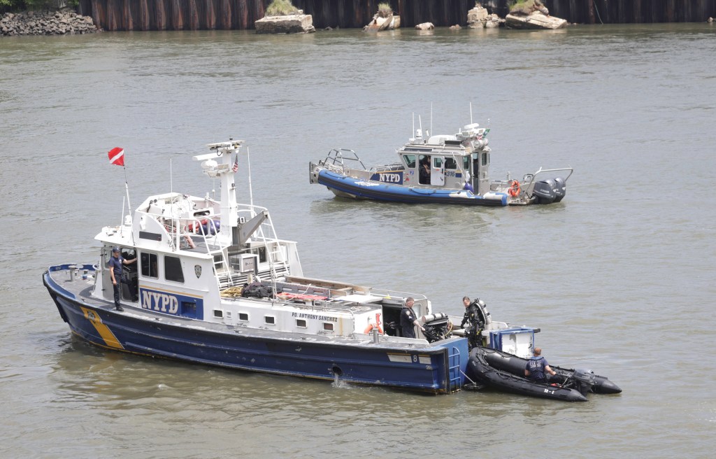 One of the NYPD's boats in the East River as divers searched on Friday.
