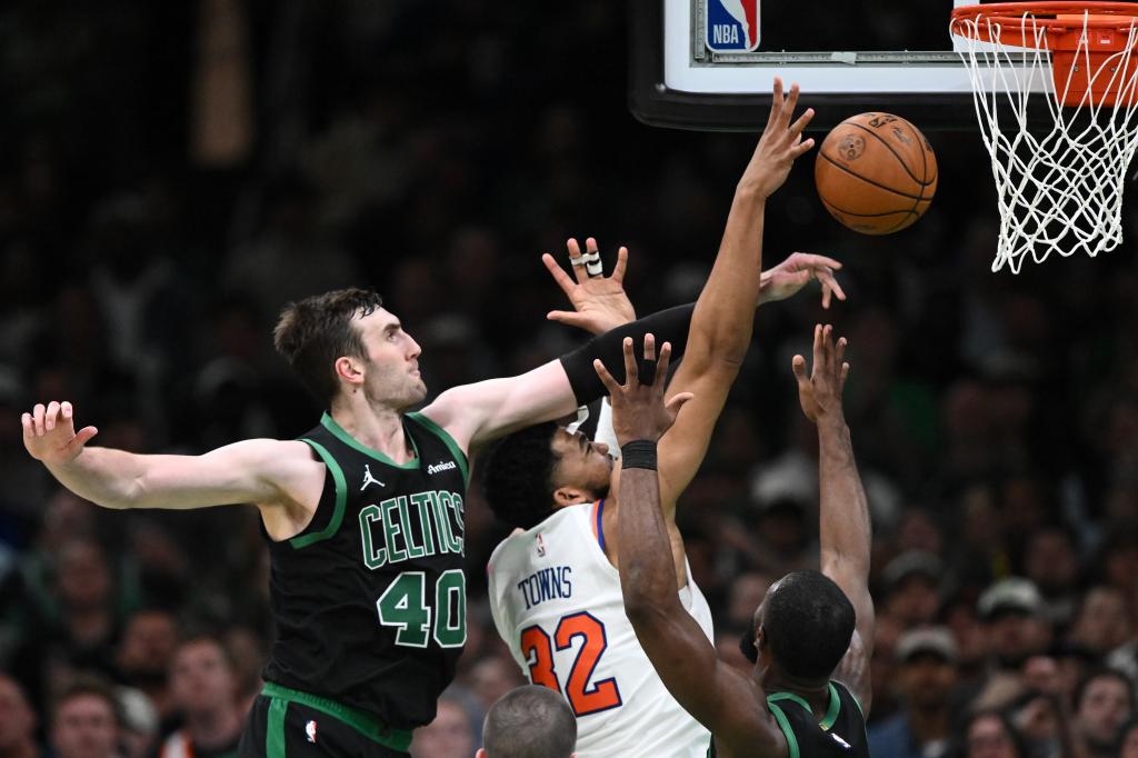 Luke Kornet #40 of the Boston Celtics blocks a shot by Karl-Anthony Towns #32 of the New York Knicks during the second half of Game Five of the Eastern Conference Second Round NBA Playoffs at the TD Garden on May 14, 2025 in Boston, Massachusetts. 
