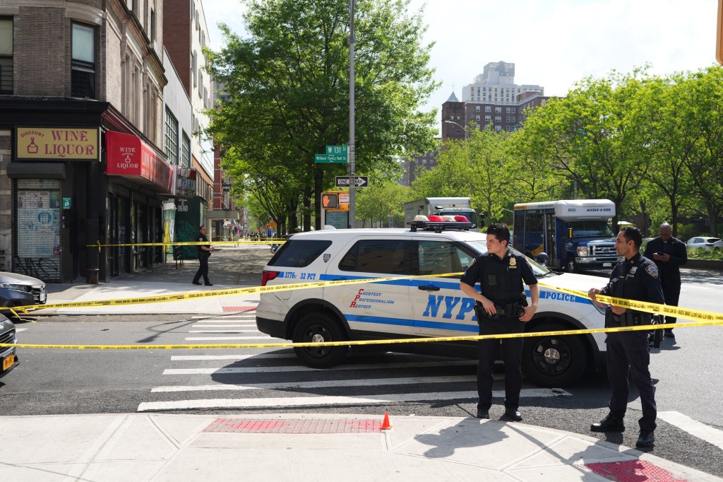Members of the New York City Police Department investigate the scene of a shooting in the vicinity of 110 W. 131 St.