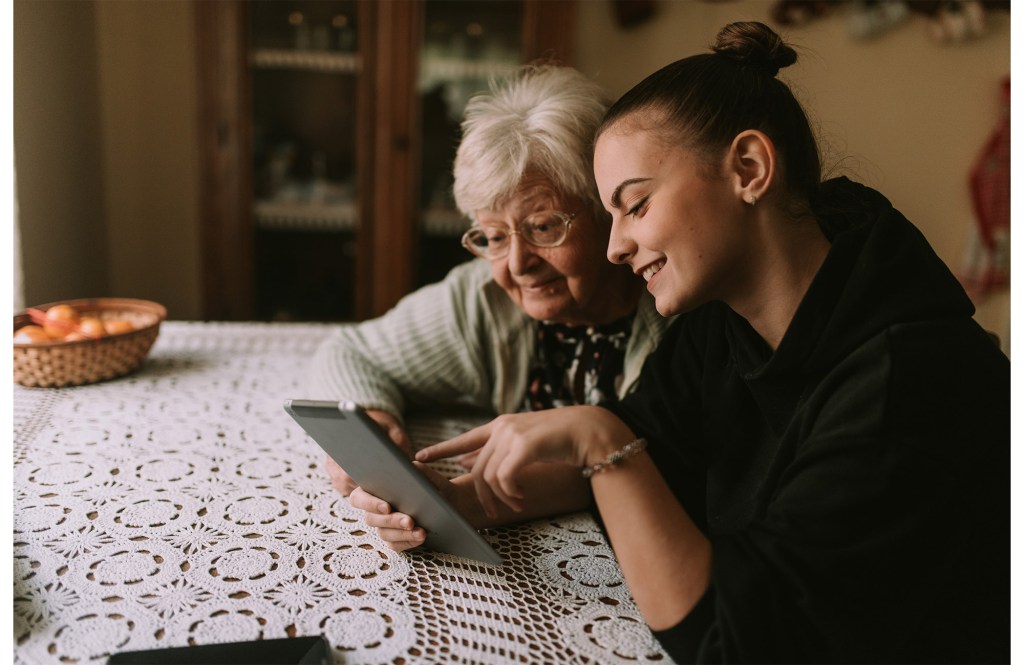 Two women searching AARP plans