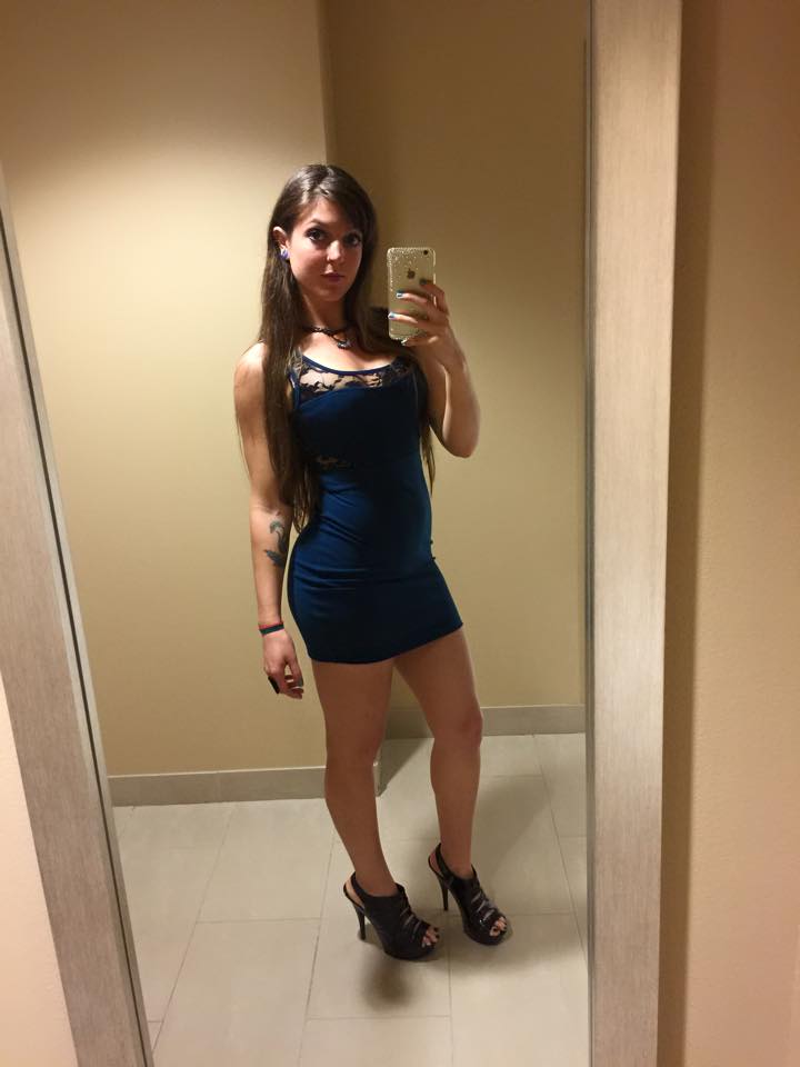 Yates takes a mirror selfie while wearing heels and a tight dress.