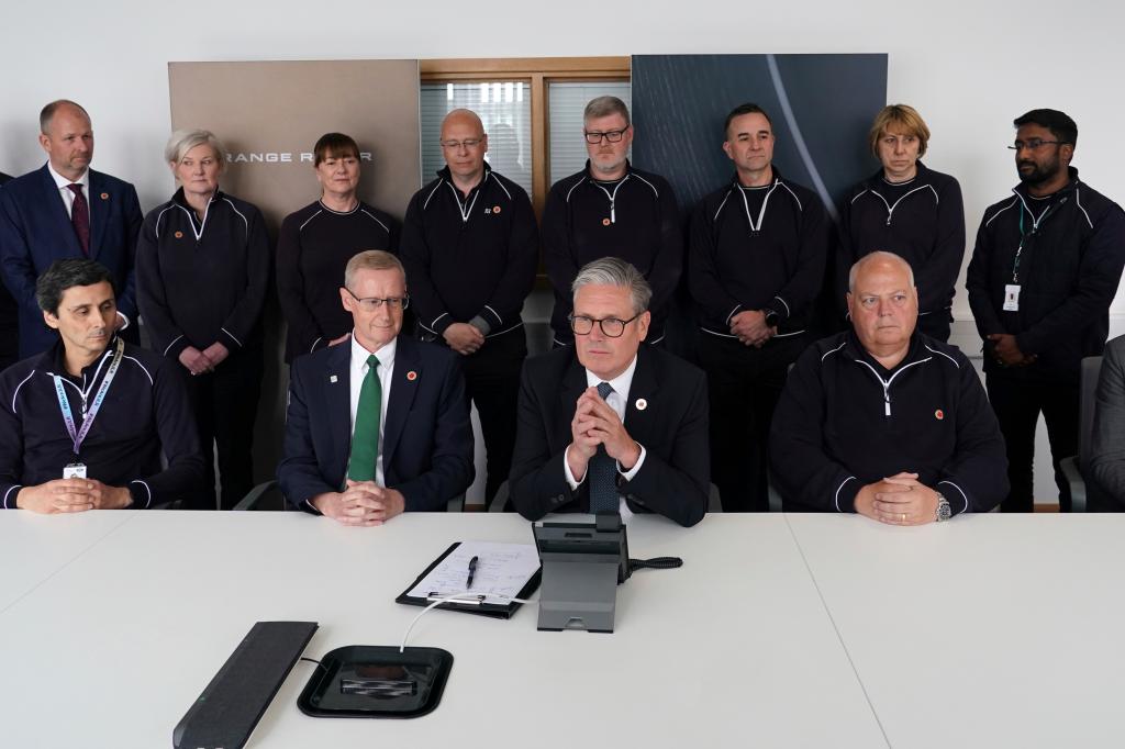 Britain's Prime Minister Keir Starmer speaks on the phone to US President Donald Trump at a car factory in the West Midlands, Thursday, May 8, 2025.