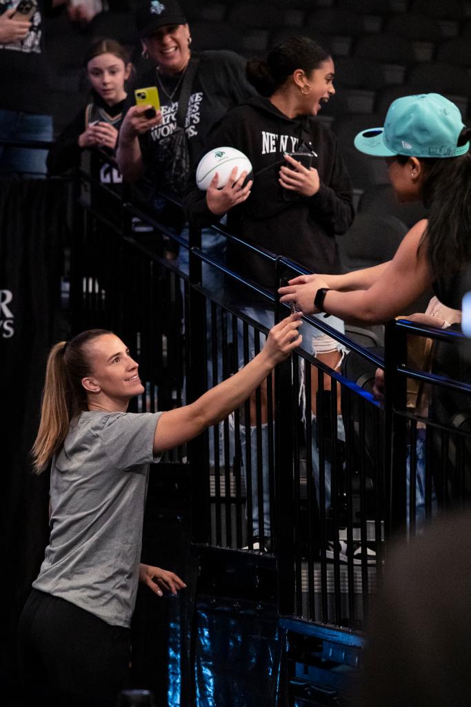 Sabrina Ionescu #20 of the New York Liberty signs autographs for fans prior to a pre-season matchup against the Connecticut Sun at Barclays Center. 
