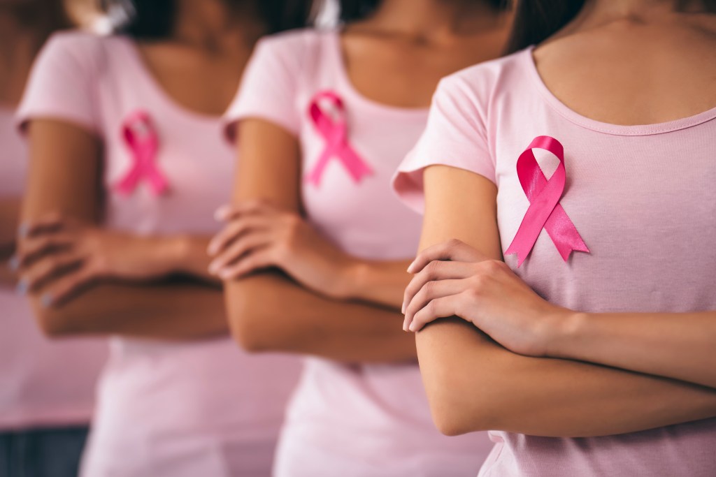 Cropped image of a multiracial group of young women wearing pink ribbons in support of breast cancer awareness