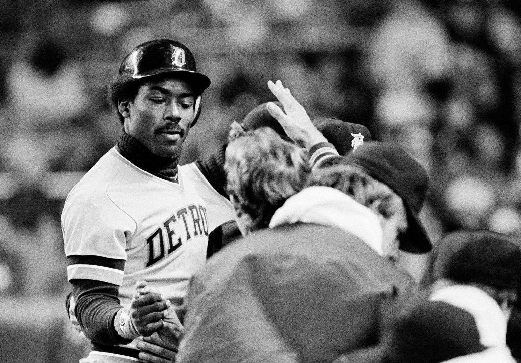Detroit Tigers right fielder Chet Lemon receiving a low-five from teammates in dugout after hitting a home run, dated April 22, 1982