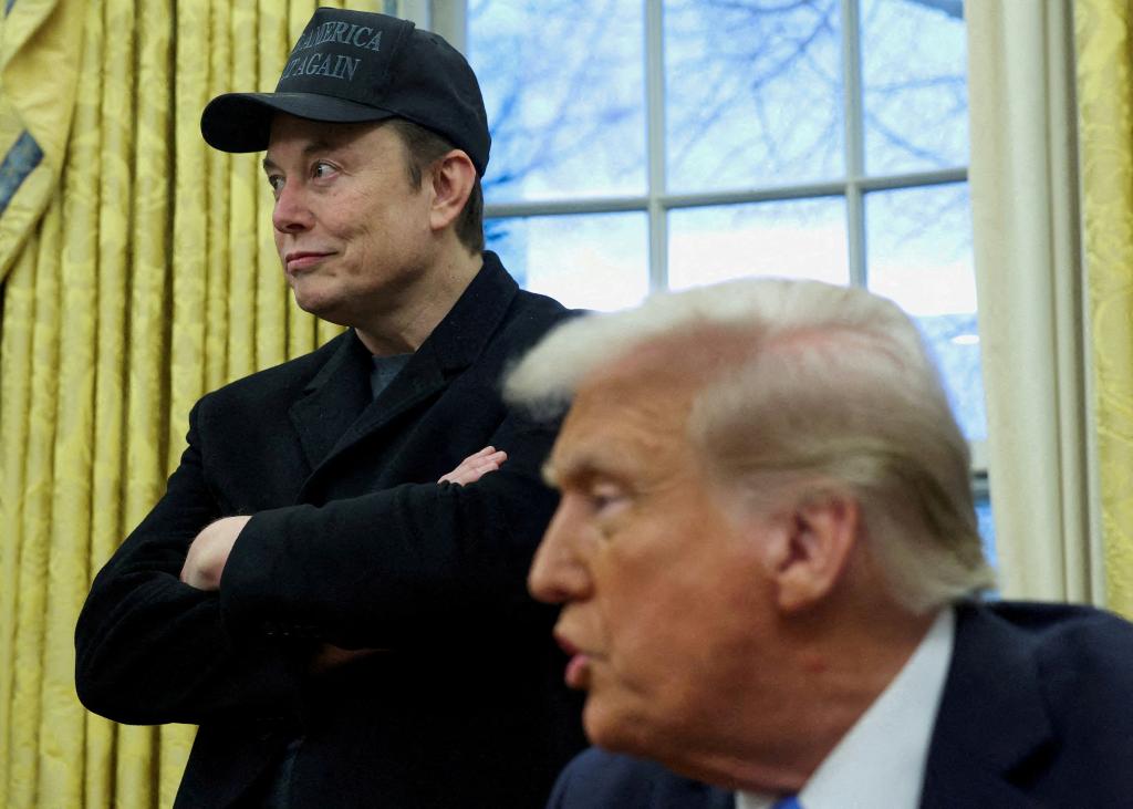 Elon Musk listening to U.S. President Donald Trump in the Oval Office, White House, February 11, 2025