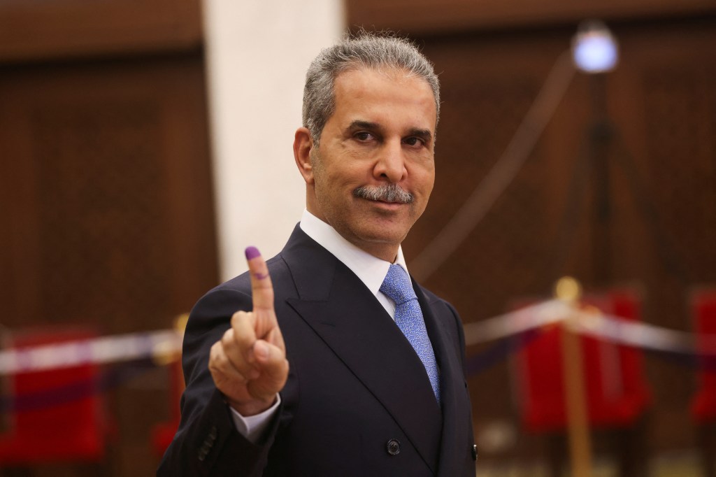 Faiq Zidan, head of Iraq's Supreme Judicial Council, holding up a finger. 