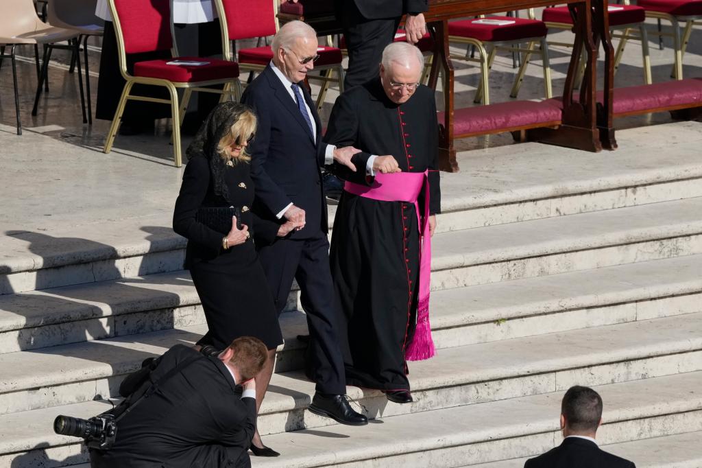 Biden getting assisted down a staircase after arriving at Pope Francis' funeral in St. Peter's Square with former first lady Jill Biden on April 26, 2025.