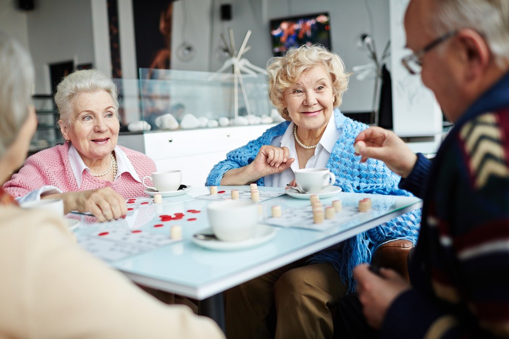 Research has suggested that brain-challenging activities like puzzles and games may help lower the risk of dementia by helping to maintain cognitive function. Here, a group of seniors play a game.