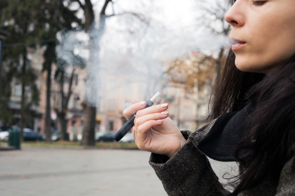A woman smokes an HTP. 