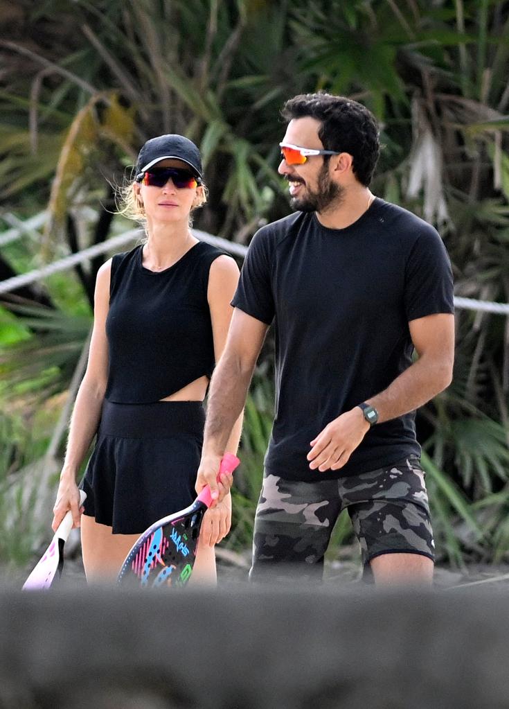 Gisele Bundchen playing beach tennis with boyfriend Joaquim Valente in Miami Beach prior to a rain shower