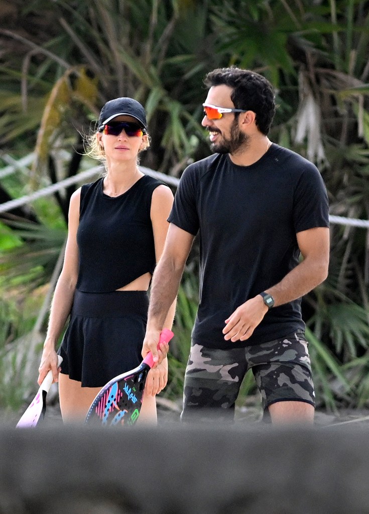 Gisele Bundchen playing beach tennis with boyfriend Joaquim Valente in Miami Beach prior to a rain shower