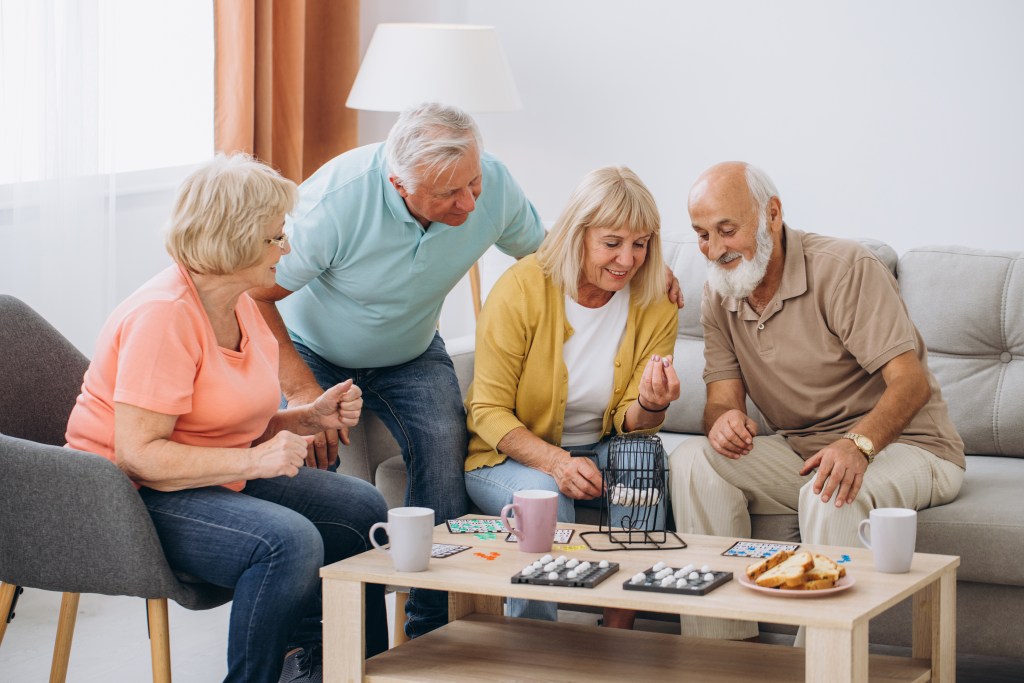 A new study suggests that a curious mind may actually help reduce dementia risk. Here, a group of seniors plays a game.