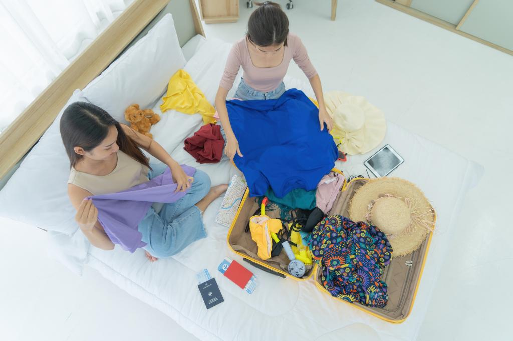 girls prepare clothes to go on holiday vacation traveling trip with travel luggage on bed in bedroom at home. 