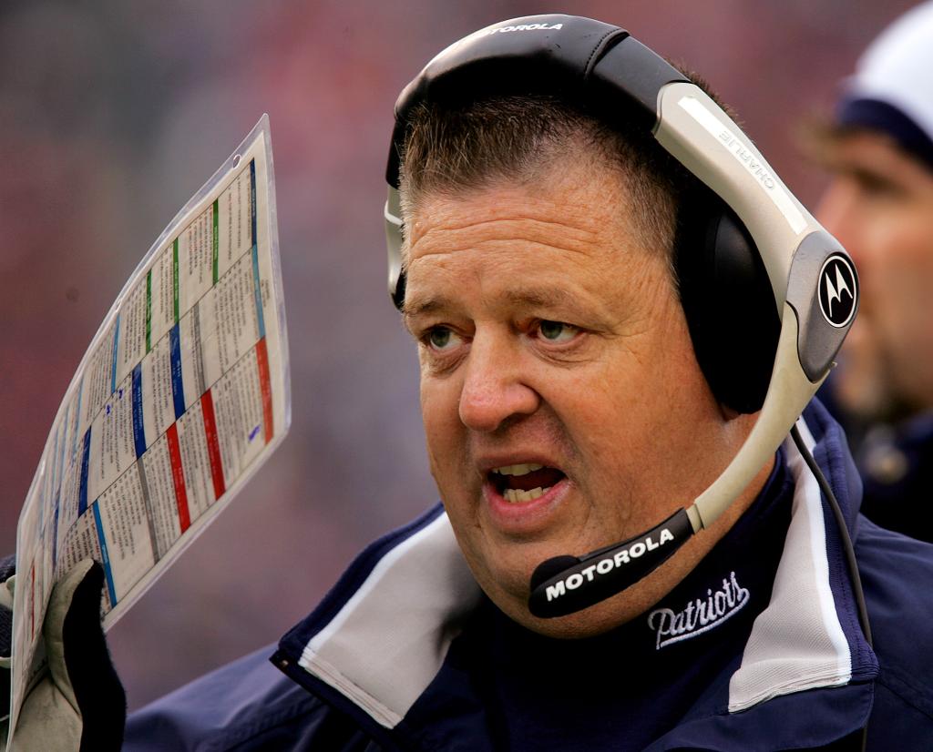 New England Patriots offensive coordinator Charlie Weis shields his mouth with a play card as he calls the next one in against the Cincinnati Bengals in Foxboro, Mass., Sunday afternoon Dec. 12, 2004. Officals at Notre Dame University are talking with Weis and say they are close to hiring him as their new head coach. 