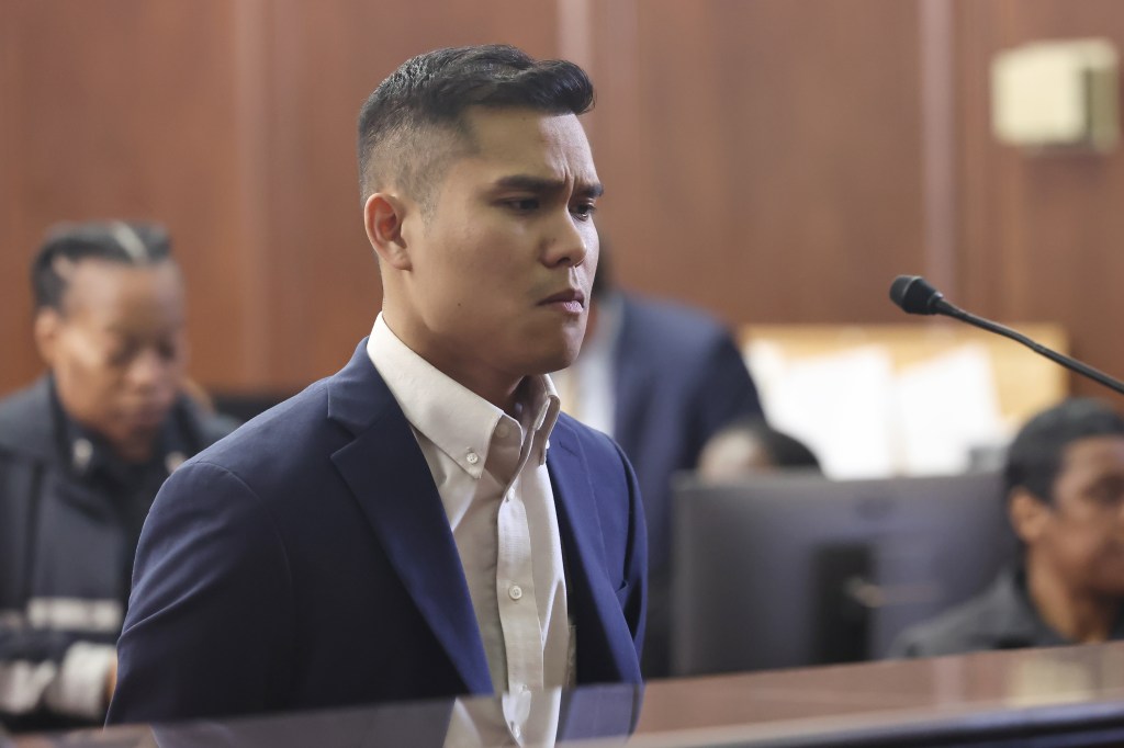 tran in court, wearing a dark blue blazer and white button down with no tie