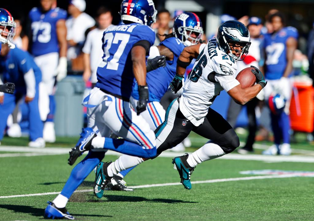 Philadelphia Eagles running back Saquon Barkley (26) runs for yardage against New York Giants cornerback Tre Hawkins III (37) during the second half, Sunday, Oct. 20, 2024 in East Rutherford, N.J. The Philadelphia Eagles won 28-3.