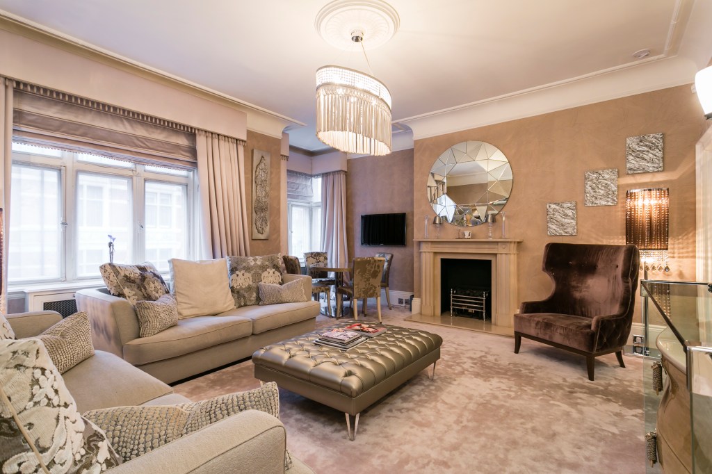The living room features large windows and a fireplace.