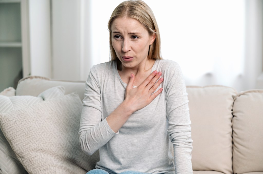 Heart disease is the leading cause of death in the US, claiming the lives of about 700,000 Americans each year. Here, a woman holds her hand to her chest.