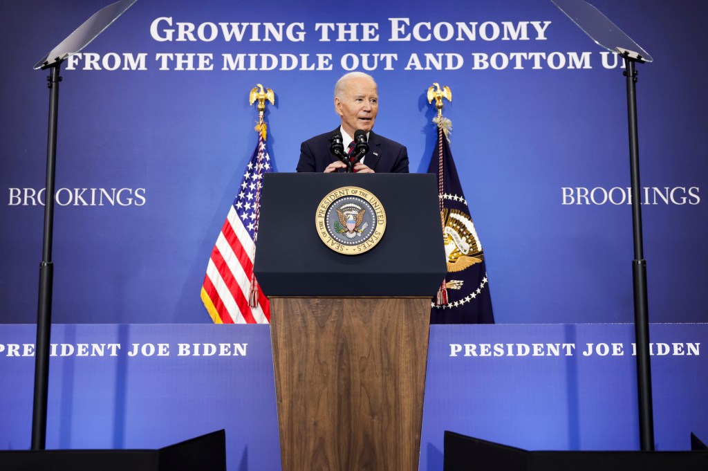 President Biden speaking at a podium about the US economy.