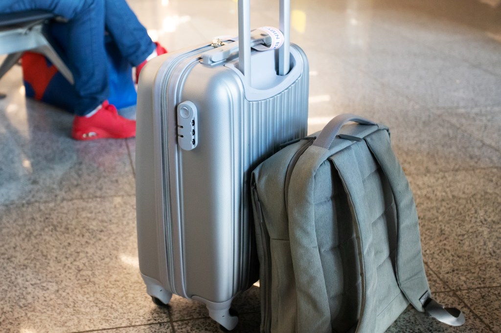 Suitcase and backpack in airport.