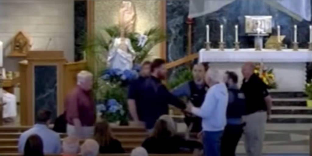 NFL player Jake McQuaide being removed from a church service by police.