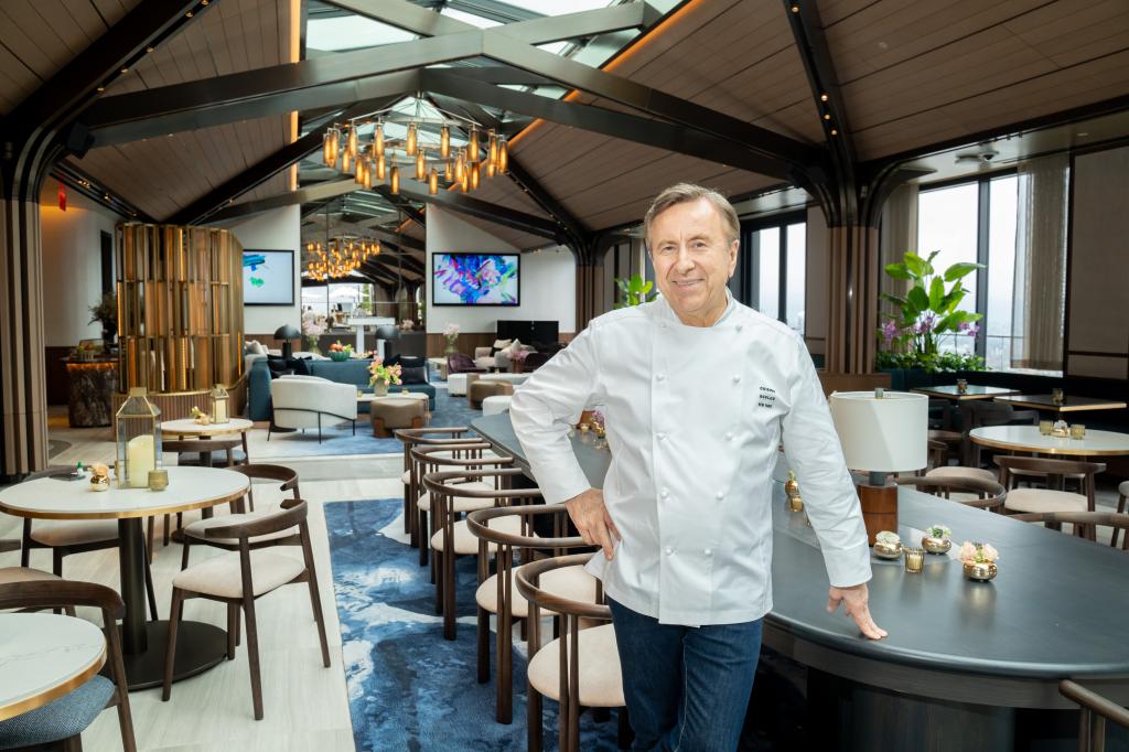 Chef Daniel Boulud standing in his new restaurant.