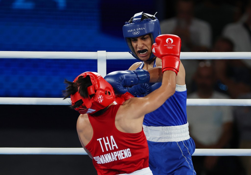 Two female boxers competing in a match at the Paris 2024 Olympic Games.