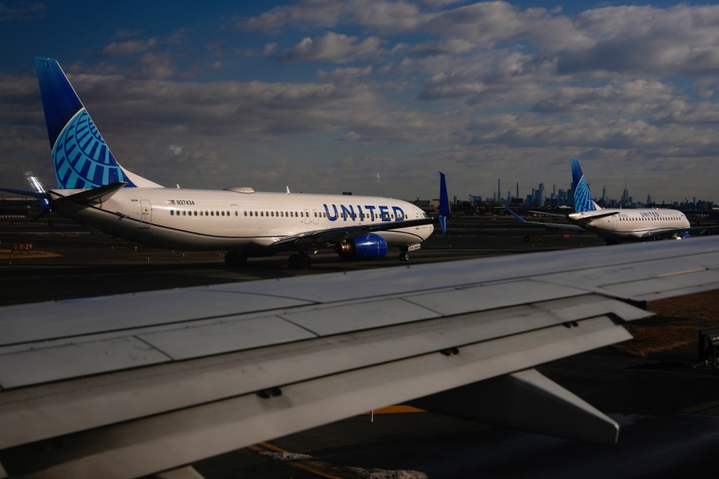 Two United Airlines planes on a tarmac.