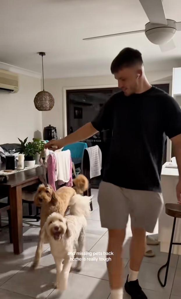 A young couple smiling outdoors, sharing their story about travelling rent-free across Australia by using a pet-sitting platform.